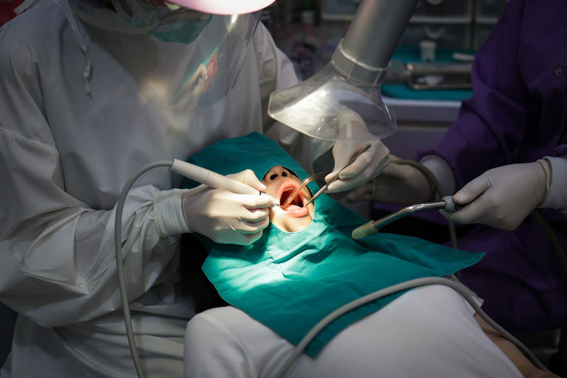 Dental Patient Undergoing Procedure With Extraoral Suction